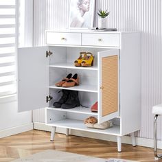 a white shoe cabinet with shoes on it