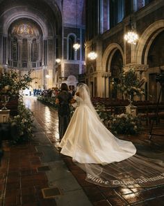 a bride and groom walking down the aisle at their wedding ceremony in an old church