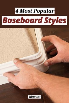 a man is working on the baseboard with his hand and pointing to it in front of