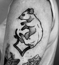 a man's arm with a rat on it