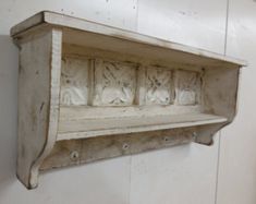 an old wooden shelf with carvings on it