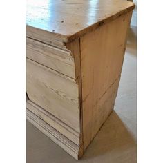 a wooden dresser sitting on top of a carpeted floor