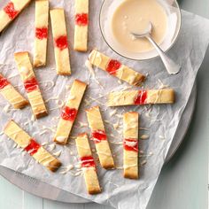 strawberry shortbreads on parchment paper with bowl of yogurt