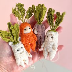 small crocheted carrots and radishes in the palm of someone's hand