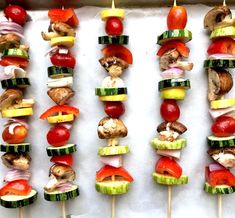 several skewers of vegetables and meat on sticks