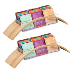 two wooden racks filled with different types of teas and packets on top of each other