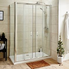 a walk in shower sitting on top of a wooden floor