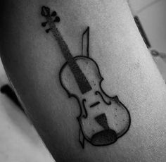 a black and white photo of a violin tattoo