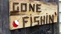 a wooden sign that says gone fishing on it