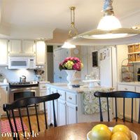 a kitchen and dining room with white cabinets