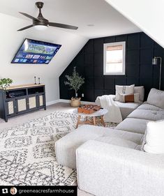 a living room filled with furniture and a flat screen tv mounted to the side of a wall