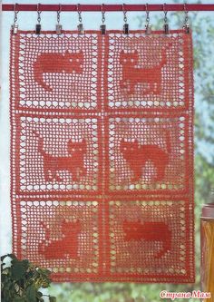 an orange curtain with elephants on it in front of a window and a potted plant