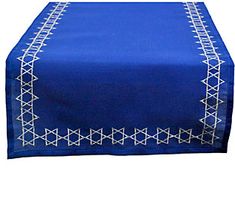 a blue table runner on top of a wooden table