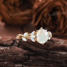 an opalite ring sitting on top of a piece of wood