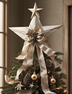 a decorated christmas tree with gold ornaments and a large star on it's top