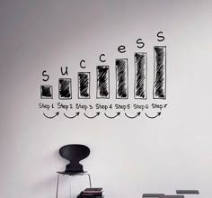 a room with a chair, table and wall sticker on it that says success