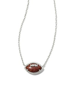 Cheer on your favorite team with the Kendra Scott Football Short Pendant Necklace in Silver! Featuring an adorable football pendant and dainty silver chain, this is the perfect layering necklace! This necklace is the perfect fall accessory! Features: Kendra Scott Style: 9608865358 Color: Silver Women’s Necklaces 14k Silver Plated Spring ring clasp closure Kendra Scott Necklace Hypoallergenic 19" chain, 0.68"L X 0.41"W foot ball pendant Cheer Accessories Ideas, Dr Accessories, Short Pendant Necklace, Foot Ball, Kendra Scott Necklace, Jewelry Aesthetic, Jewelry Accessories Ideas, Accessories Ideas, Ball Pendant