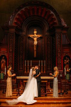 a bride and groom are standing in front of the alter