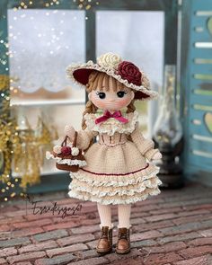 a doll is dressed in a dress and hat