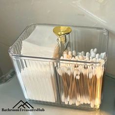 a clear container filled with lots of toothbrushes