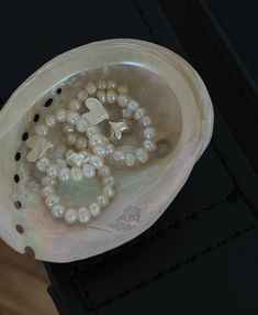 a white bowl filled with pearls on top of a table