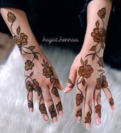 two hands with hendi designs on them