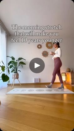 a woman standing on top of a yoga mat in front of a window with the words, the morning stretch that will make you feel 10 years younger