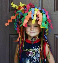 a young boy with dreadlocks standing in front of a door