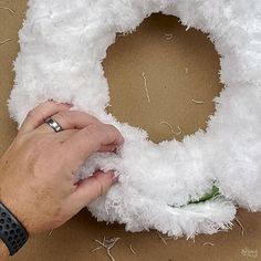 someone is making a wreath out of fake fur