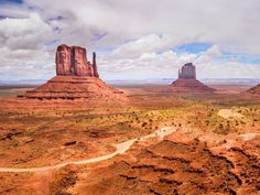 an aerial view of monument buttes in the distance