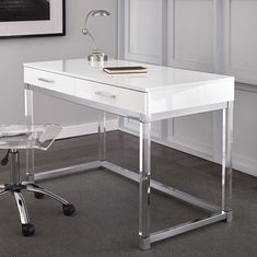 a white desk with chrome legs and a clear chair next to it in front of a window