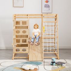 a little boy sitting on top of a wooden structure in the middle of a room