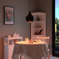 a table with a white cloth on it in front of a book shelf and window