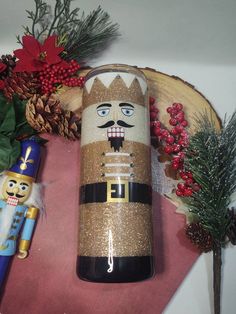 a wooden nutcracker is sitting next to other christmas decorations