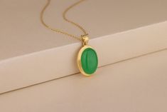 This green jade pendant necklace is a must-have! Crafted from high quality genuine jade that is carefully matched, this piece has a smooth, polished finish and beautiful color. It also comes in 10K and 14K solid gold or sterling silver. Made for everyday wear or special occasions, this green jade necklace will be a treasured addition to any outfit! Details of the product Material: 10K and 14K Solid Gold, Silver Gemstone: Green Jade Gemstone Gemstone Size: 12x16 mm Unique Gift For people whom you love; Mom, Girlfriend, Wife, Fiance, Best Friend; Dainty Gift Idea; Valentine's Day Gift, Birthday Gift, Anniversary Gift, Gift For Engagement or Wedding, Promise Gift, Christmas Gift, Black Friday Gift, Mother's Day Gift, International Women's Day Gift, Memorial Gift. By gifting this elegant produ Oval Jade Necklaces With Hallmark, Hallmarked Oval Jade Necklaces, Oval Jade Necklace For Anniversary, Good Luck Necklace, Jade Necklace, Jade Pendant, Jade Green, Memorial Gifts, Ladies Day