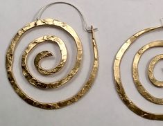 "These swirl hoops are hand pound, shaped and polished. Great for every day. The texture and hand forged quality catches the light and give these simple earrings dimension. Available in solid copper, bronze or sterling silver with hand made ear wires of sterling silver. Large 2 1/8\" H x 1 7/8\" W Ancient spiral meaning: Evolution, Life, Consciousness, Creation Finish: Satin finish is a matte brushed finish. High shine is a brilliant high polish. Each pair is individually shaped, pound and match Spiral Meaning, Sacred Spiral, Spiral Jewelry, Dope Jewelry Accessories, Spiral Earrings, Dope Jewelry, Simple Earrings, Hand Forged, Artisan Jewelry