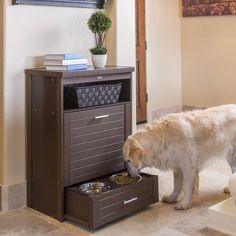 a dog eating food out of a drawer