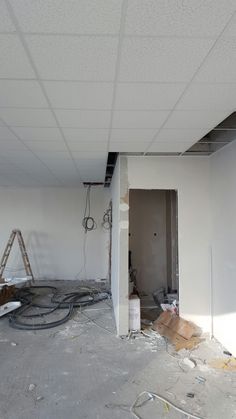 an unfinished room with white walls and drywall