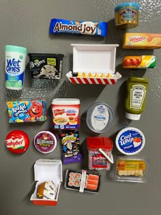 the refrigerator door is covered with various food items and containers, including yogurt