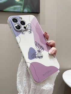 a woman holding up her phone case with butterflies on the front and back cover in purple