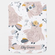 a white blanket with pink and yellow flowers on it, the name lily grace written in gold