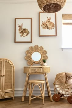 a baby's room with pictures on the wall