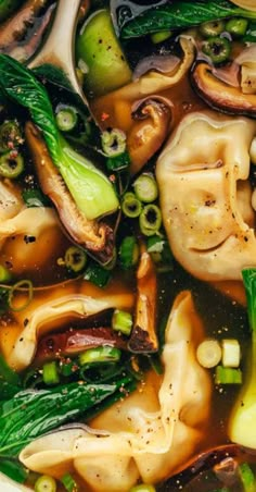 a bowl filled with soup and vegetables on top of a table