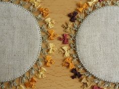 two embroidered circles on a wooden surface