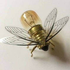 a light bulb shaped like a bee sitting on top of a table