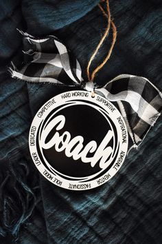 a black and white label with the word coach hanging from it's side on a blue shirt