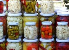 many jars filled with different types of vegetables