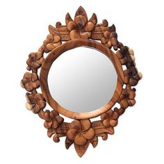 a wooden mirror sitting on top of a white wall