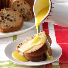 someone pouring butter onto a muffin on a plate