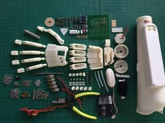 an assortment of electronic components laid out on a green table with wires and other accessories